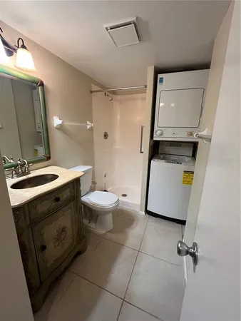 a bathroom with a sink a toilet and mirror