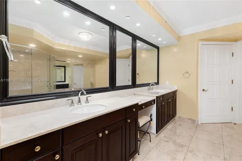 a bathroom with a double vanity sink and a mirror