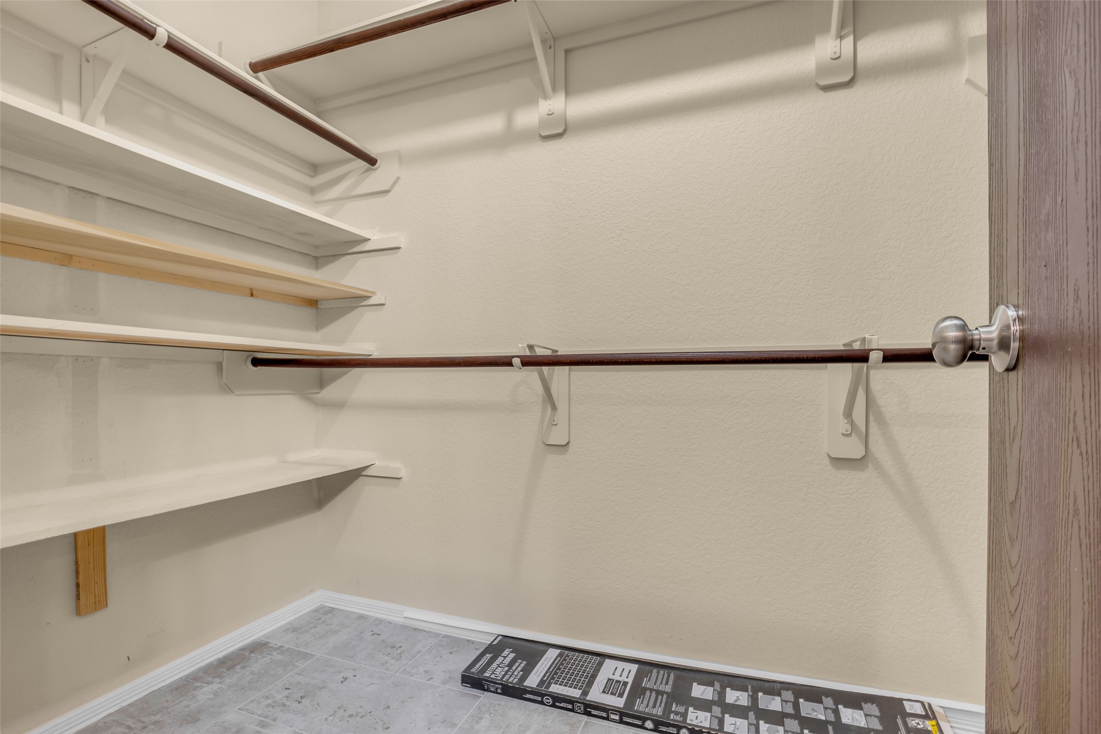 242 Sunset Path North Conroe, TX 77316 - Photo 28 of 37 Primary closet features double hanging bars and built in shelving. 242 SUNSET PATH N - Request your tour today!
