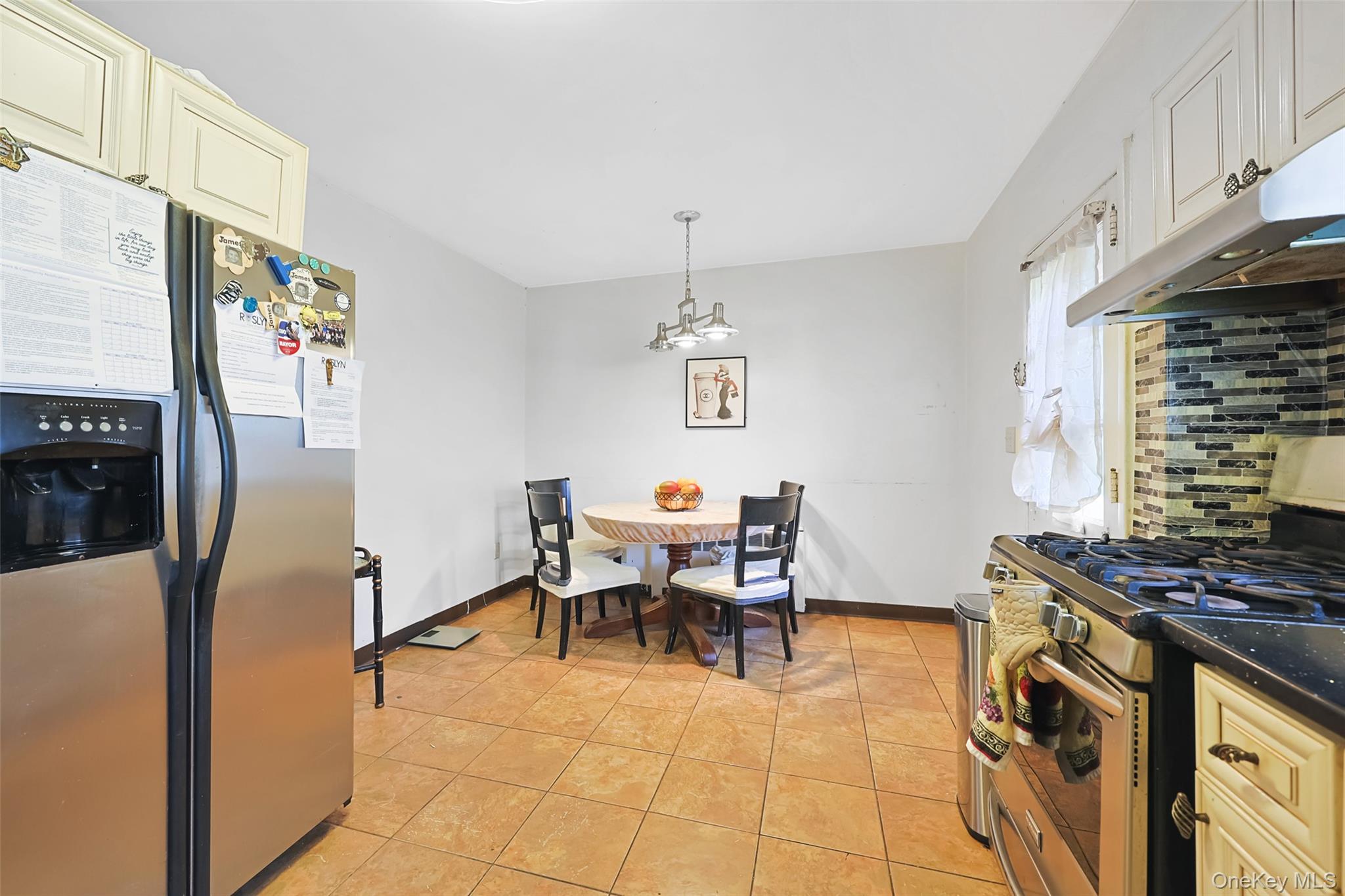 84 Middle Neck Road Roslyn, NY 11576 - Photo 13 of 44 a dining room with furniture and a chandelier