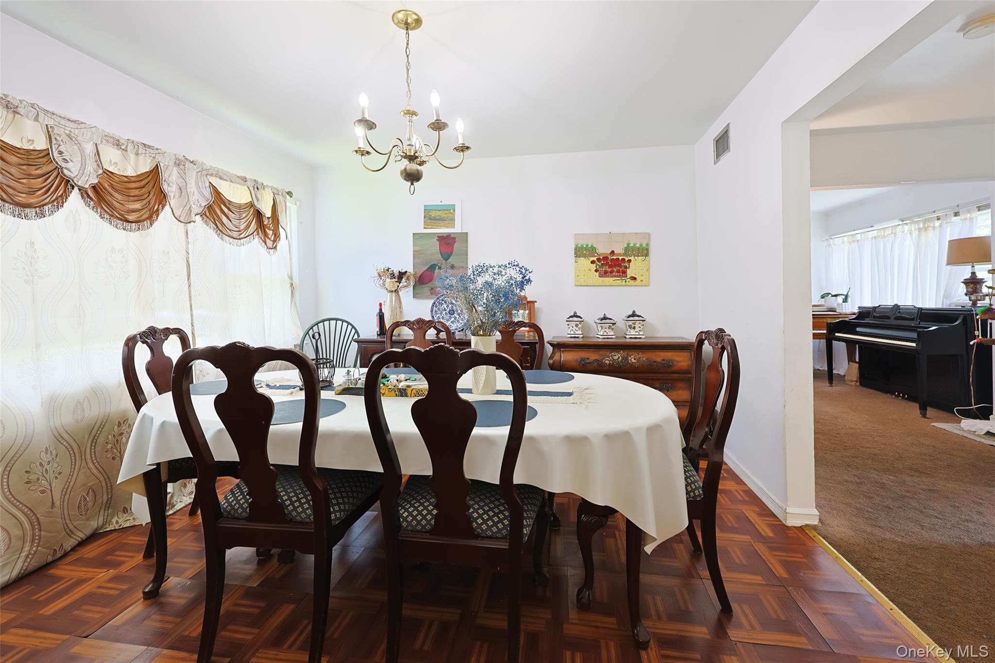 84 Middle Neck Road Roslyn, NY 11576 - Photo 16 of 44 a view of a dining room with furniture wooden floor and chandelier