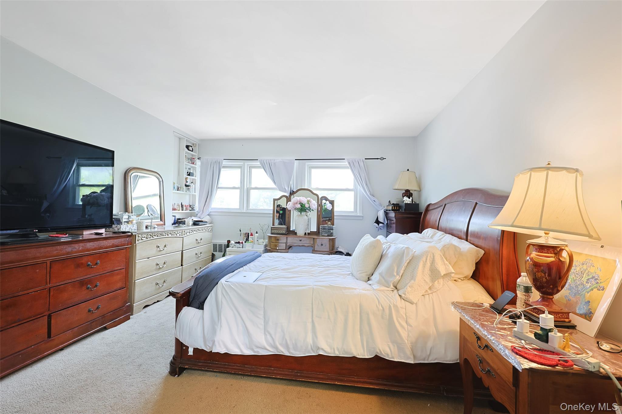 84 Middle Neck Road Roslyn, NY 11576 - Photo 20 of 44 a bedroom with a bed and a flat screen tv