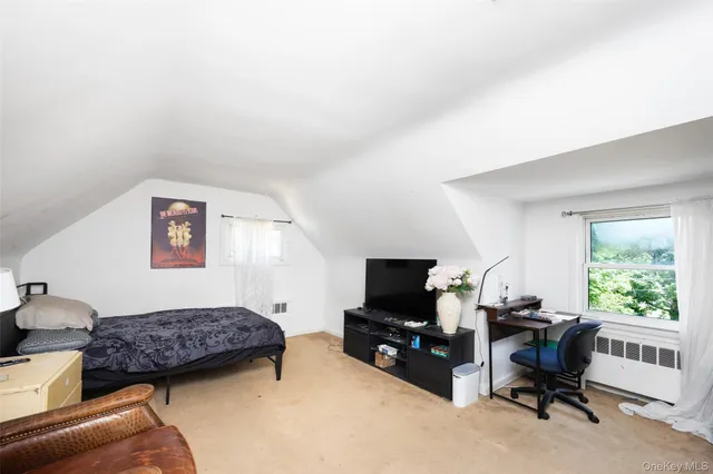 a view of a livingroom with workspace and a window