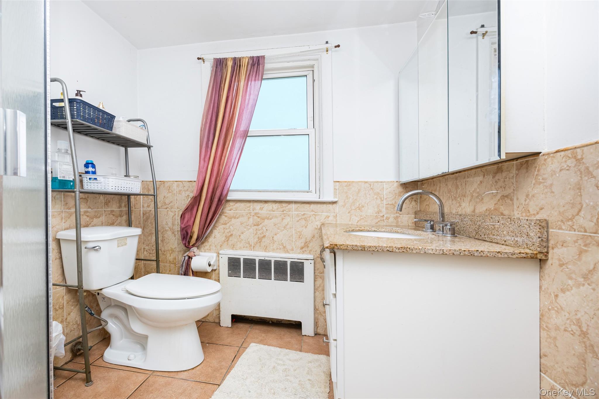 84 Middle Neck Road Roslyn, NY 11576 - Photo 30 of 44 a bathroom with a sink a toilet and a window