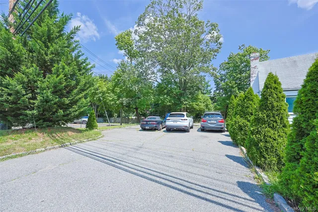 a view of a car park on the side of the road