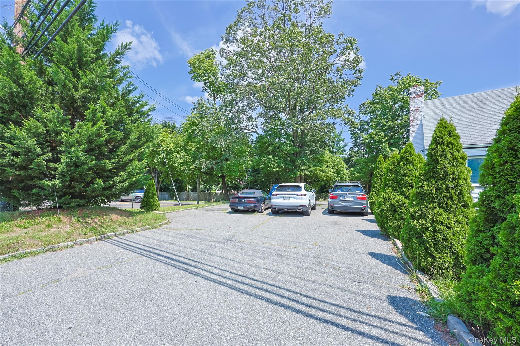 84 Middle Neck Road Roslyn, NY 11576 - Photo 34 of 44 a view of a car park on the side of the road