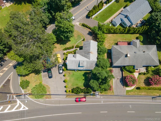 an aerial view of a house with a garden and street view