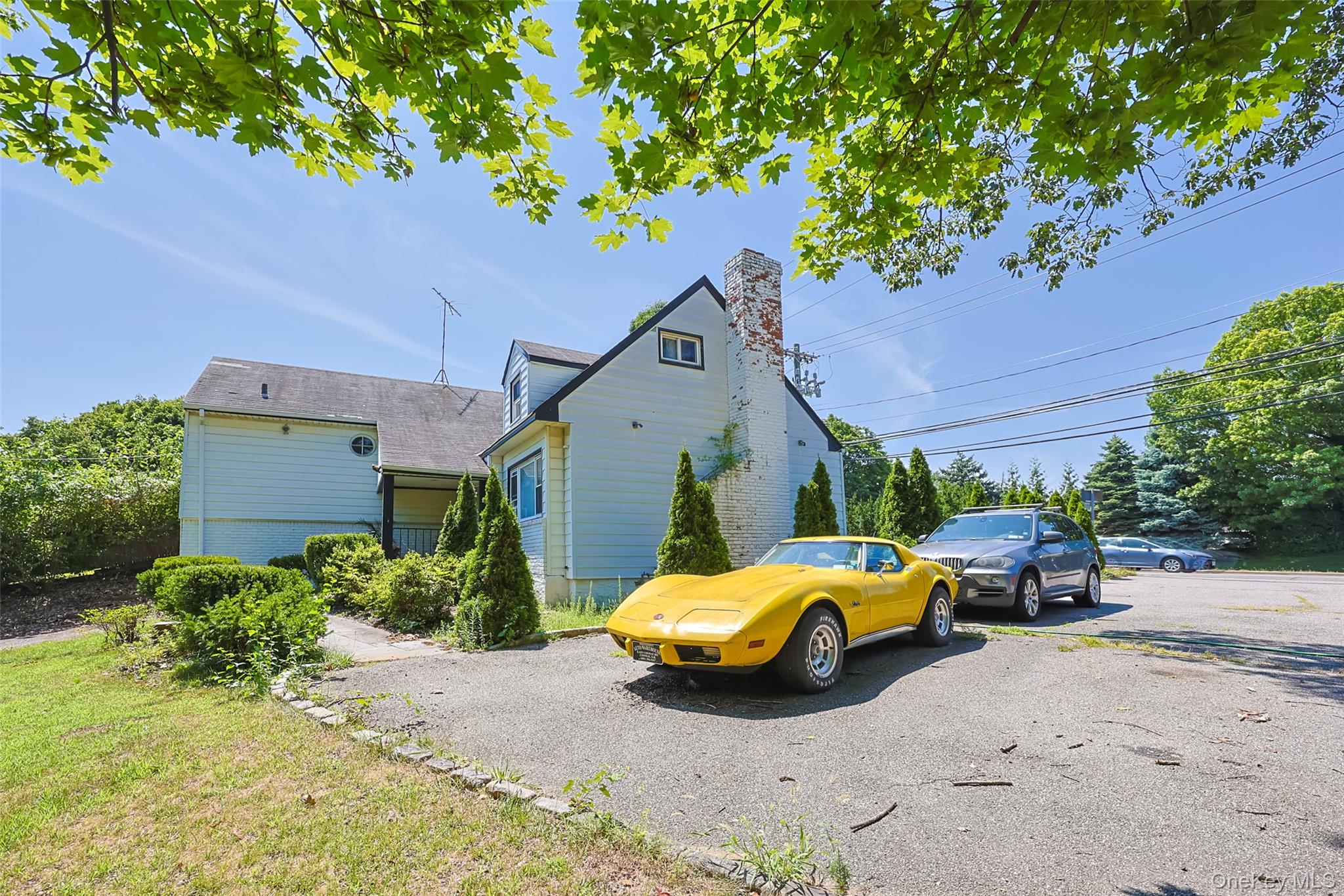 84 Middle Neck Road Roslyn, NY 11576 - Photo 4 of 44 a car parked in front of a house