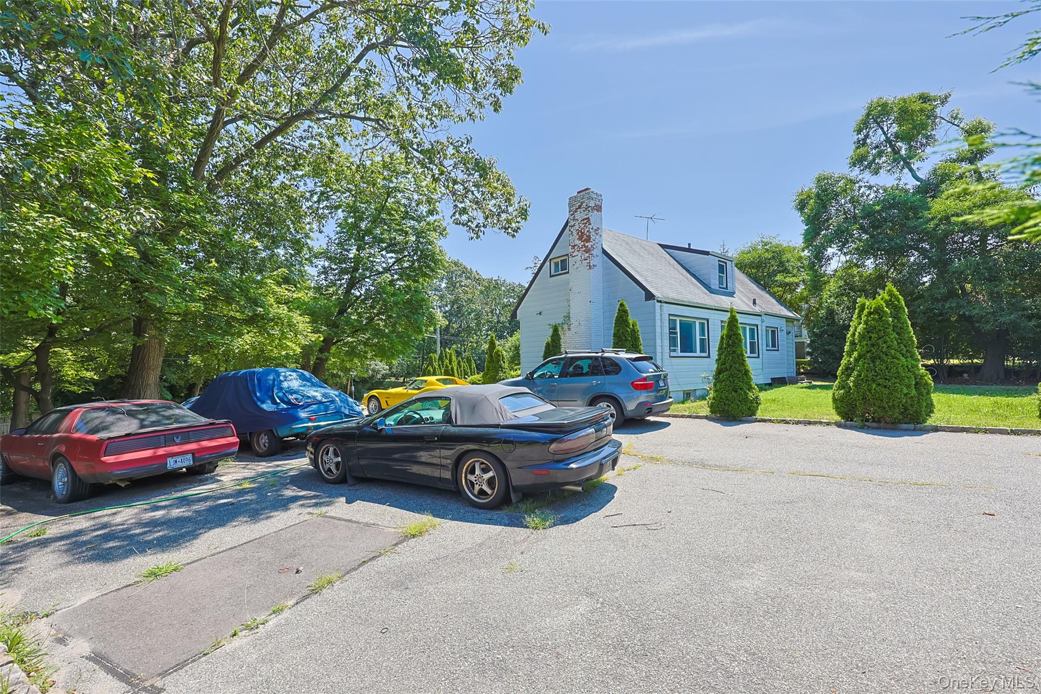 84 Middle Neck Road Roslyn, NY 11576 - Photo 5 of 44 a car parked in front of a house
