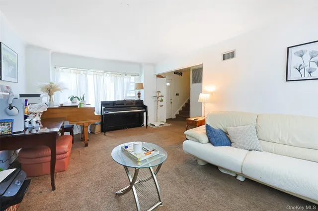 a living room with furniture and a dining table