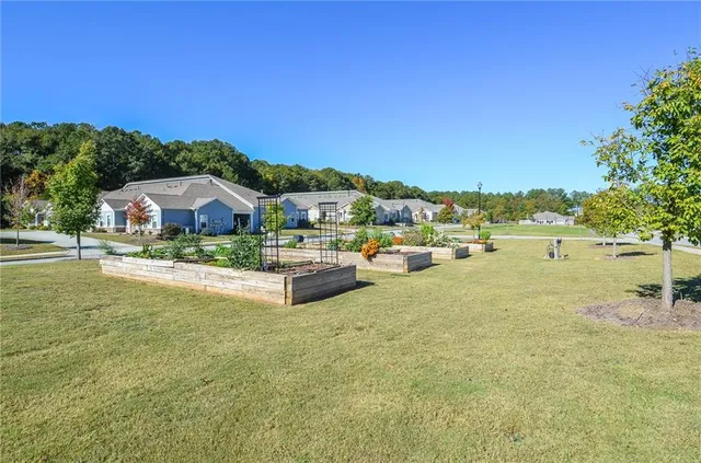 a view of a house with a yard and sitting area