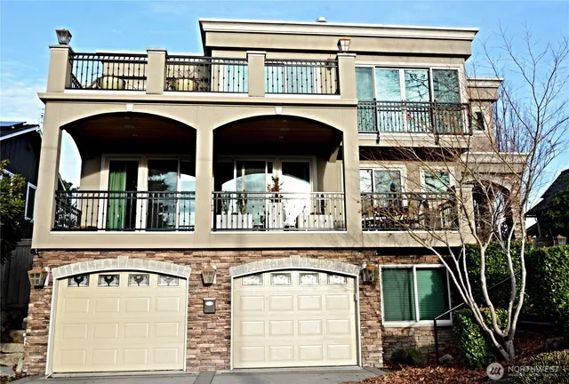 a view of a balcony with two large windows