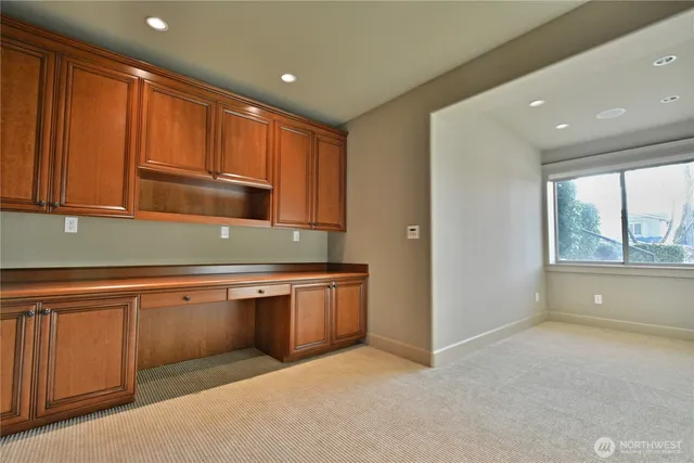 a kitchen with granite countertop sink and cabinets