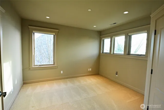 a living room with a large window and a chandelier