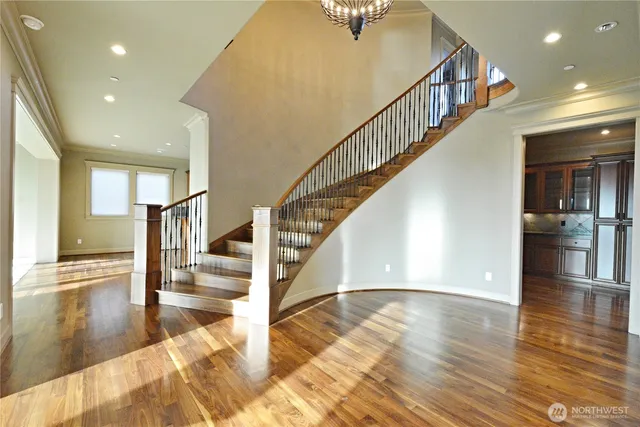 a view of entryway and hall with wooden floor