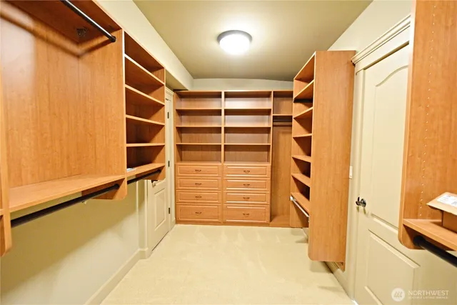 a view of a house with a balcony and car parked