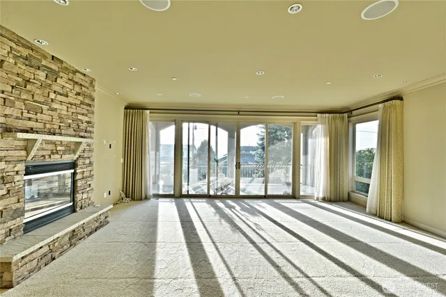 a view of a room with a fireplace and large windows