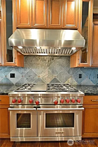 a stove top oven sitting inside of a kitchen