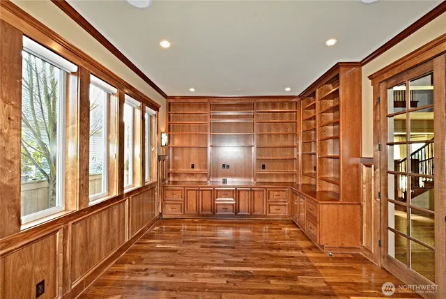 a view of a large room with wooden floor and windows