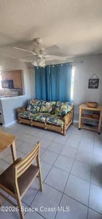 a view of a room with furniture and a window