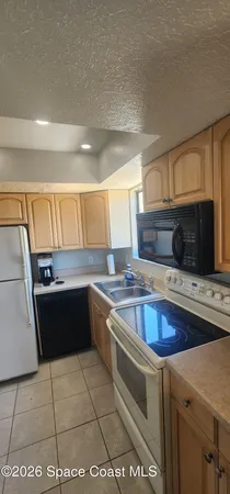 a kitchen with a cabinets and a refrigerator