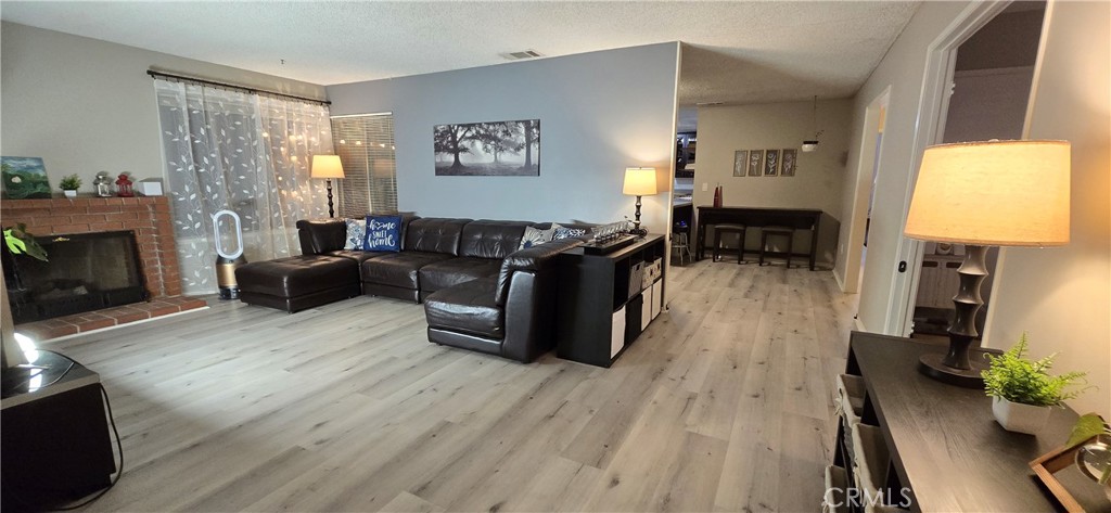 6830 Astoria Drive Riverside, CA 92503 - Photo 13 of 23 a living room with furniture a fireplace and a flat screen tv