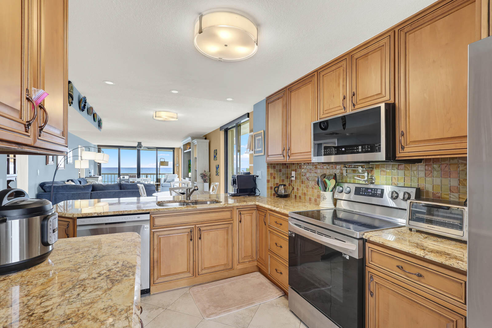 10600 South Ocean Drive, Unit 310 Jensen Beach, FL 34957 - Photo 11 of 45 a kitchen with a sink stove and microwave