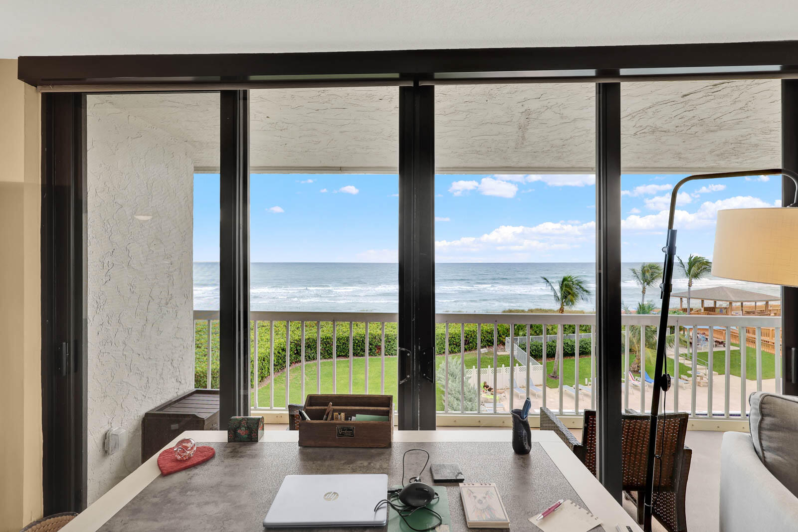 10600 South Ocean Drive, Unit 310 Jensen Beach, FL 34957 - Photo 17 of 45 a living room with a large window and floor to ceiling window
