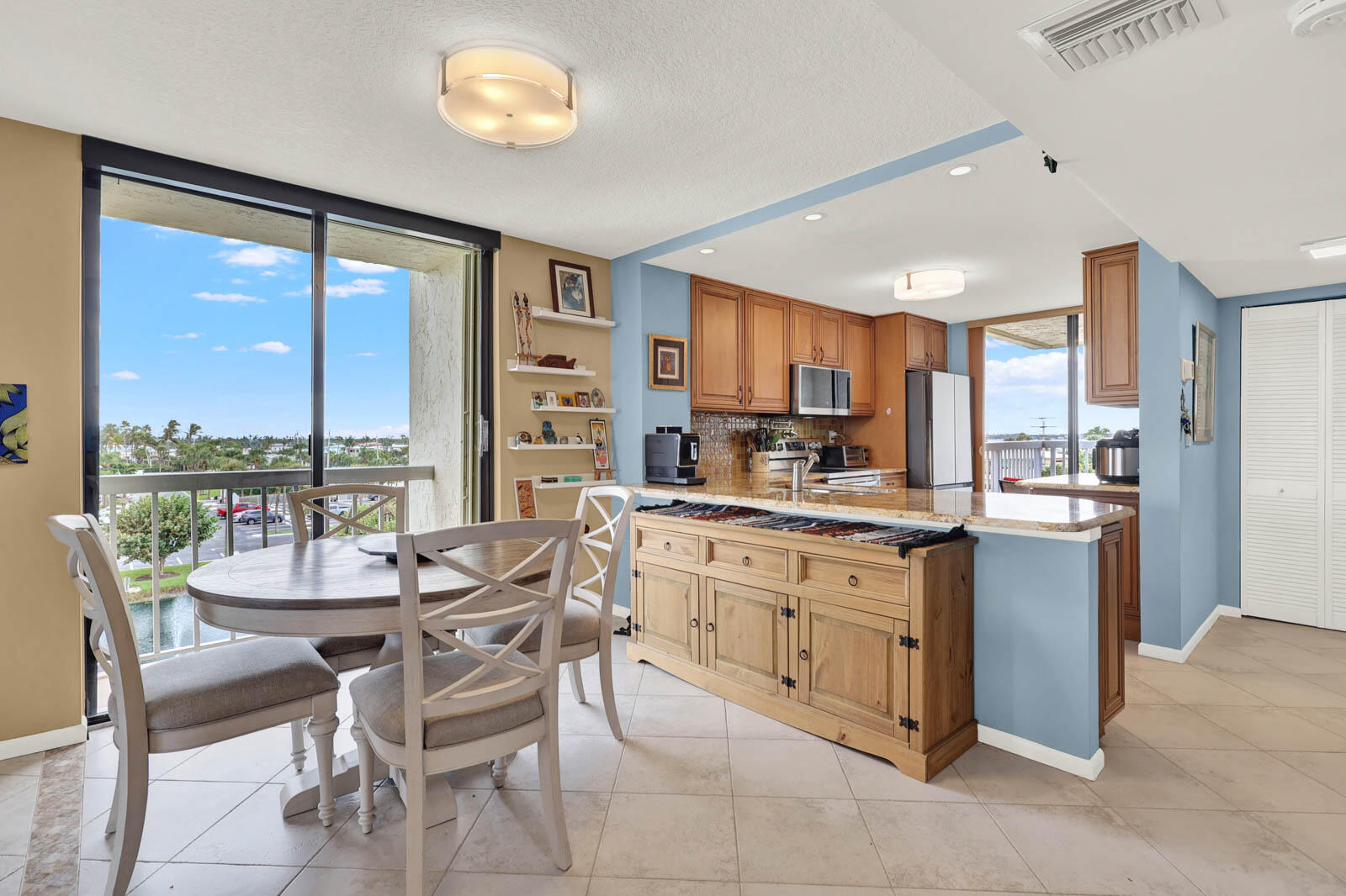 10600 South Ocean Drive, Unit 310 Jensen Beach, FL 34957 - Photo 19 of 45 a large kitchen with kitchen island granite countertop a large counter top space and stainless steel appliances