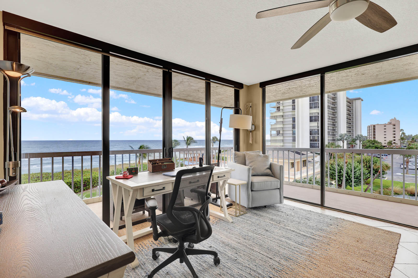 10600 South Ocean Drive, Unit 310 Jensen Beach, FL 34957 - Photo 22 of 45 a living room with furniture and a floor to ceiling window