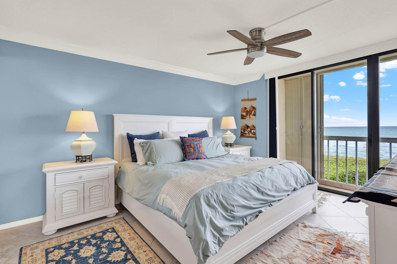 10600 South Ocean Drive, Unit 310 Jensen Beach, FL 34957 - Photo 23 of 45 a bedroom with a bed and a chandelier