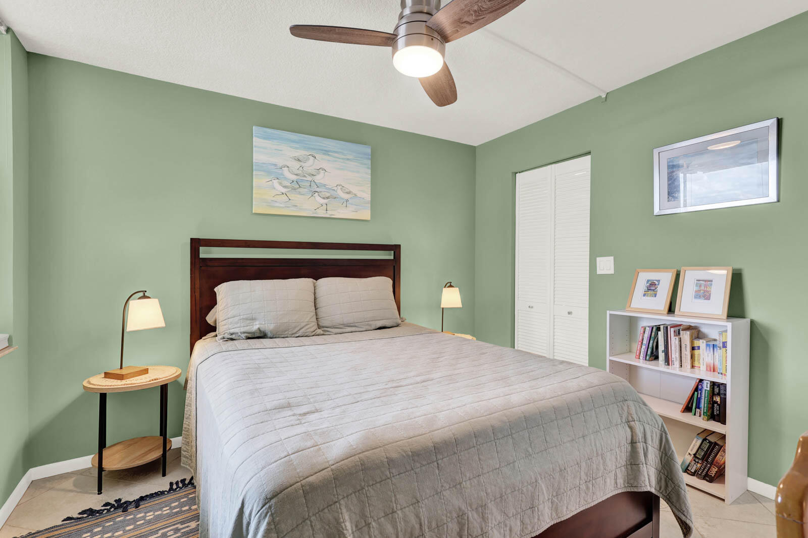 10600 South Ocean Drive, Unit 310 Jensen Beach, FL 34957 - Photo 27 of 45 a bedroom with a bed and a bookshelf