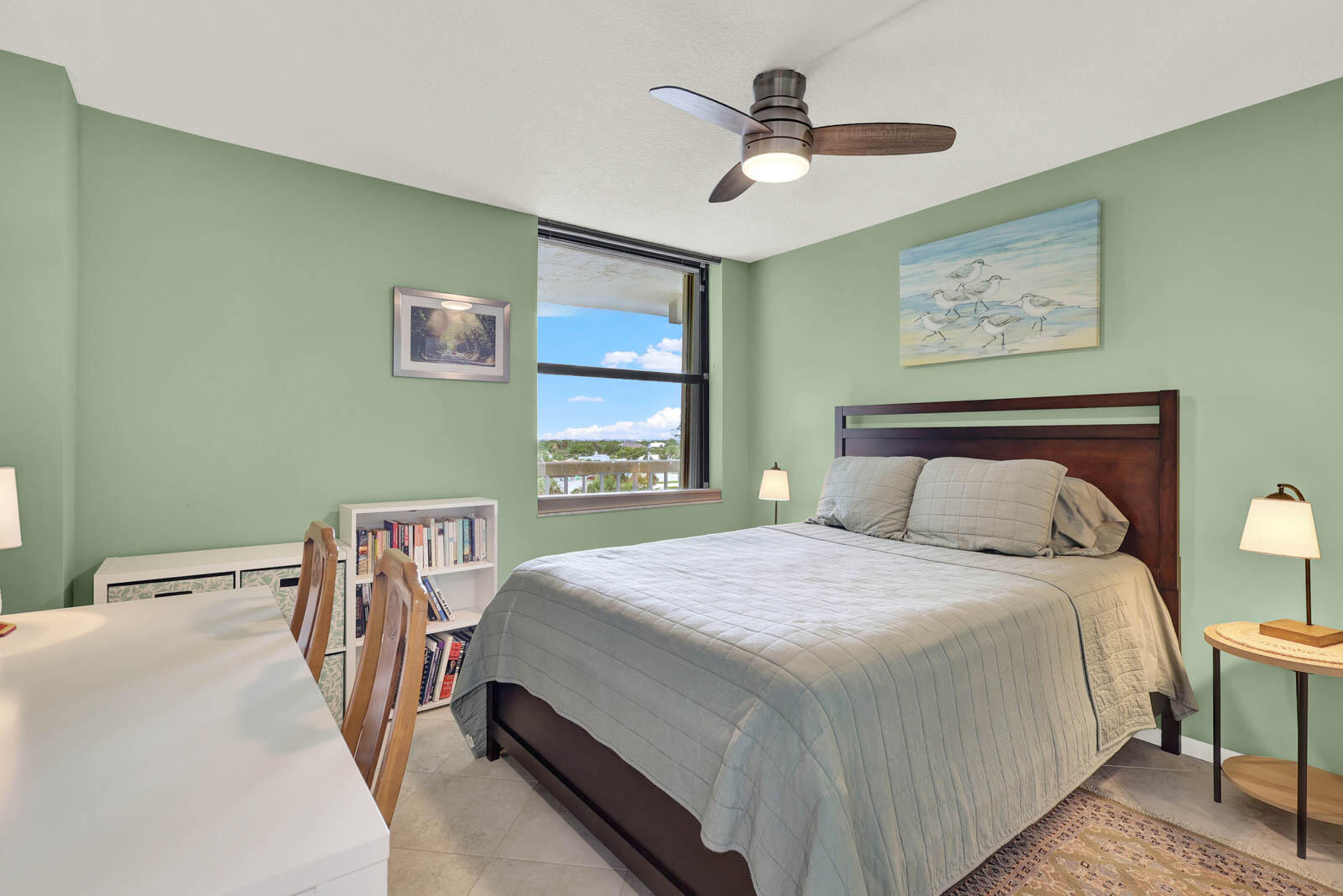 10600 South Ocean Drive, Unit 310 Jensen Beach, FL 34957 - Photo 7 of 45 a bedroom with a bed a chandelier and a dresser