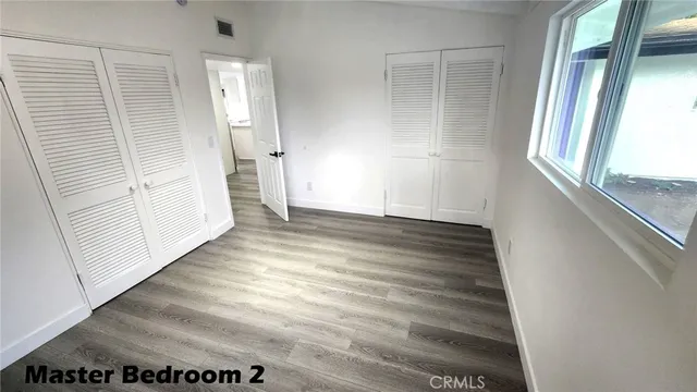 an entryway with wooden floor