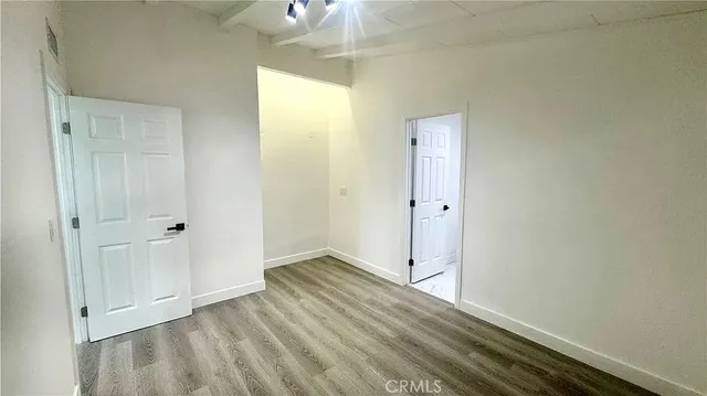 a view of an empty room and wooden floor