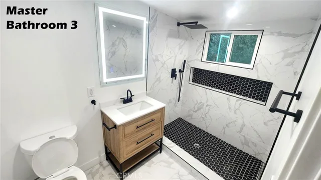 a bathroom with a sink a toilet and mirror