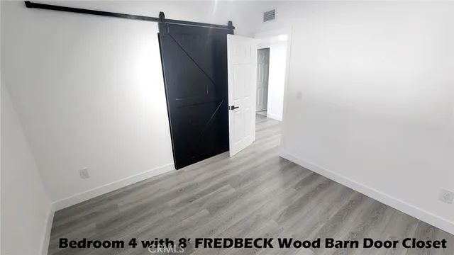 a view of closet with wooden floor