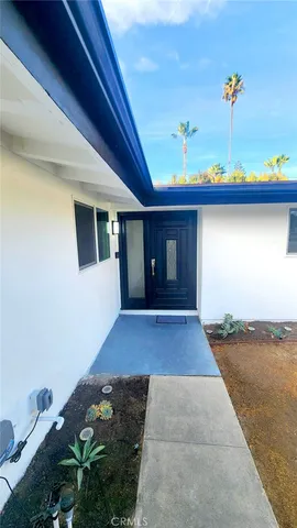 a view of a patio with table and chairs potted plants
