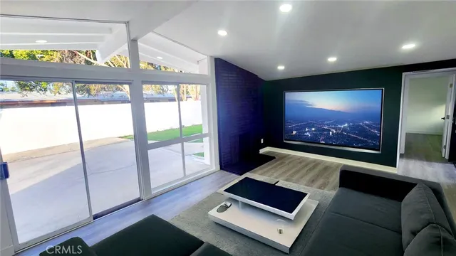 a room with furniture and a floor to ceiling window