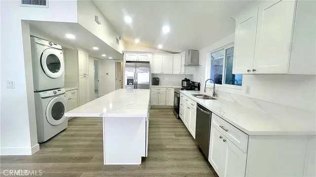 a kitchen with a sink a washer and dryer