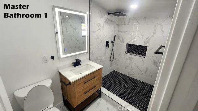 a bathroom with a sink toilet and shower