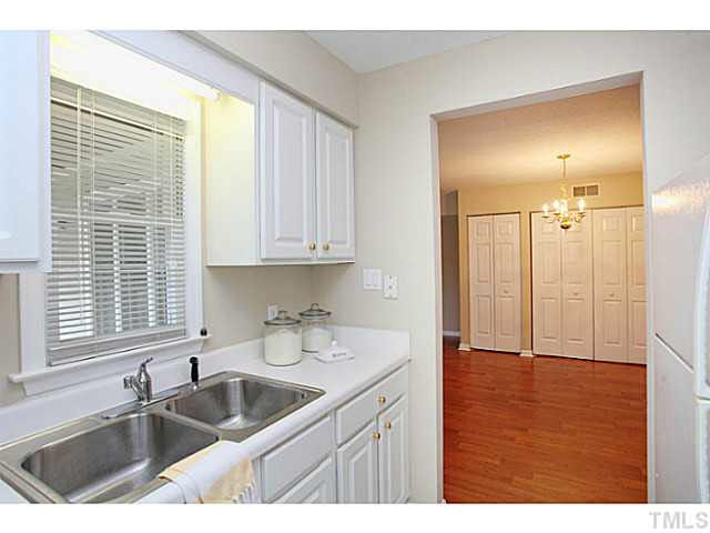 2821 Edridge Court, Unit 101 Raleigh, NC 27612 - Photo 11 of 25 a kitchen with a sink cabinets and window