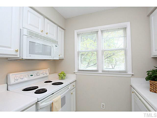 2821 Edridge Court, Unit 101 Raleigh, NC 27612 - Photo 12 of 25 a kitchen with a sink cabinets and appliances