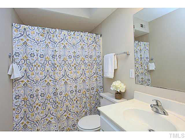 2821 Edridge Court, Unit 101 Raleigh, NC 27612 - Photo 17 of 25 a bathroom with a sink toilet and shower