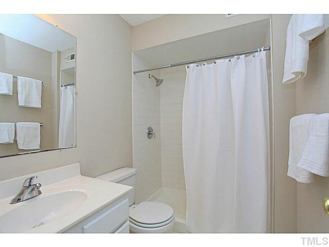 2821 Edridge Court, Unit 101 Raleigh, NC 27612 - Photo 18 of 25 a bathroom with a sink and a mirror
