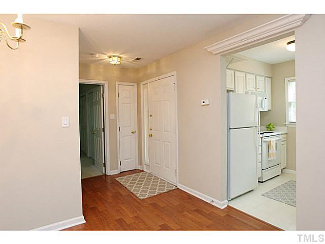 2821 Edridge Court, Unit 101 Raleigh, NC 27612 - Photo 7 of 25 a view of a livingroom with kitchen space and a refrigerator