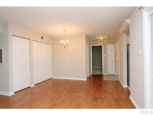 2821 Edridge Court, Unit 101 Raleigh, NC 27612 - Photo 9 of 25 a view of an empty room with wooden floor