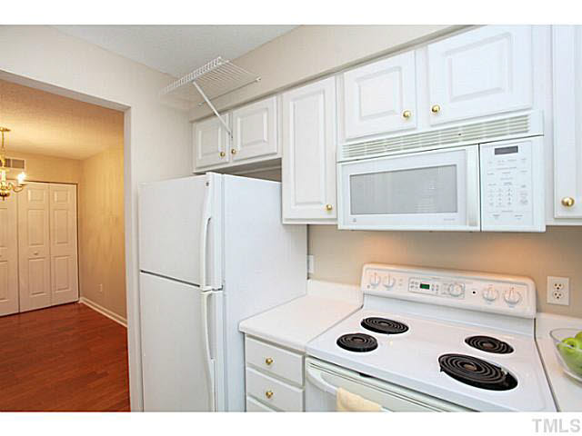 2821 Edridge Court, Unit 101 Raleigh, NC 27612 - Photo 10 of 25 a kitchen with a refrigerator sink and cabinets