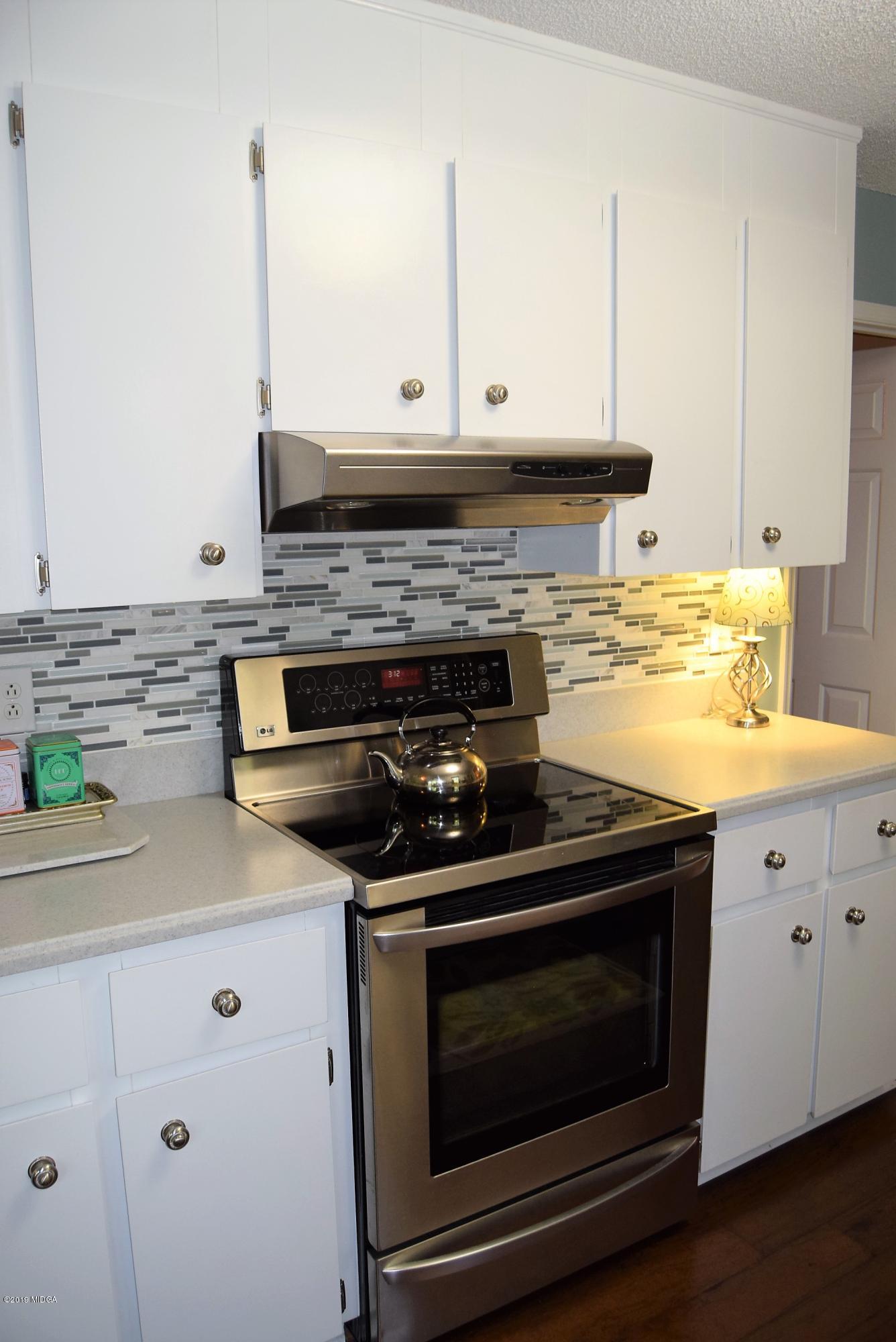 475 Stone Edge Road Macon, GA 31210 - Photo 12 of 36 a kitchen with stainless steel appliances granite countertop white cabinets and a stove a sink