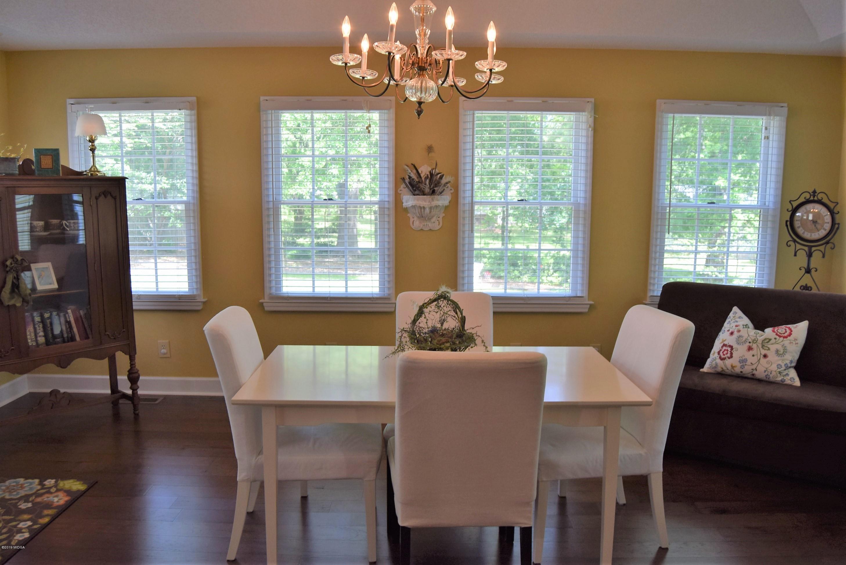 475 Stone Edge Road Macon, GA 31210 - Photo 14 of 36 a dining room with furniture a chandelier and wooden floor